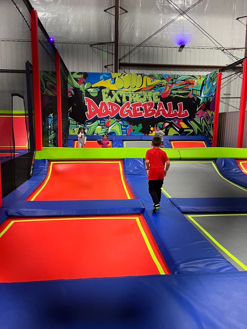 Trampoline dodgeball arena with colorful courts