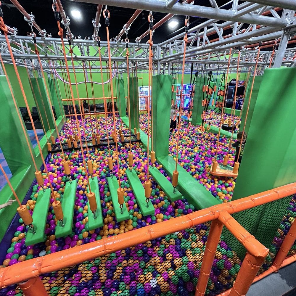 Ninja warrior crossing course over a ball pit