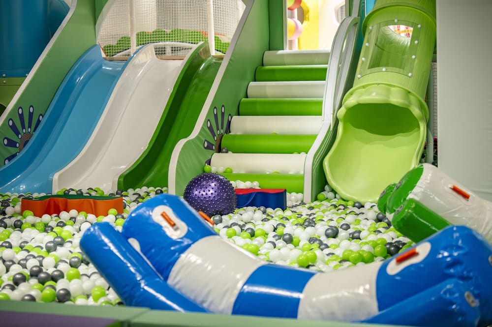 Indoor soft play structure with colorful slides