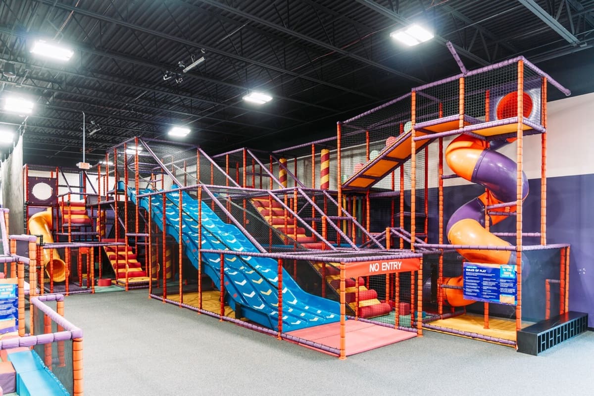 Colorful kids play zone with slides and climbing frames